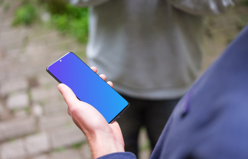 Holding Samsung Galaxy S20 mockup next to a friend