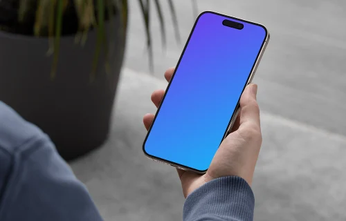 iPhone 15 Pro mockup in male hand with modern decor