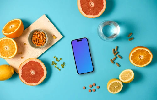 iPhone mockup with oranges and pills