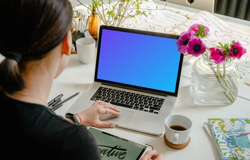 MacBook Pro mockup beside a cup of coffee and nice flowers