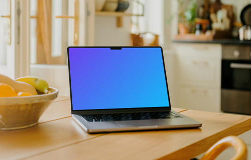 MacBook Pro mockup on a dining table beside a fruit basket