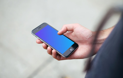 Man standing with iPhone 6s mockup on a street