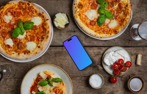 Phone mockup nearby pizza and pasta