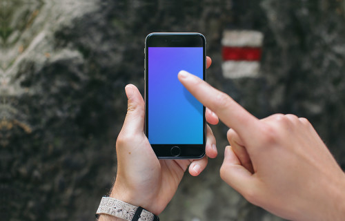 Pointing on iPhone 6 mockup in mountains