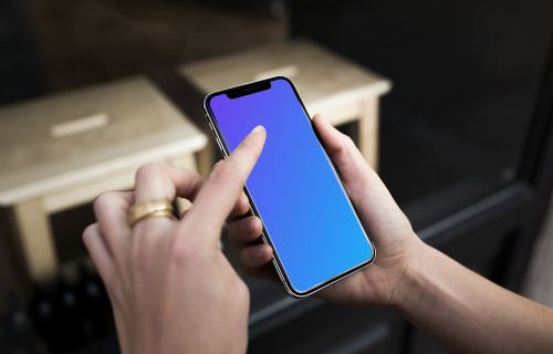 Pointing on iPhone X mockup in front of the shop