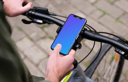 Assis sur le vélo, je tape sur l'iPhone 11 Pro mockup dans le support de vélo