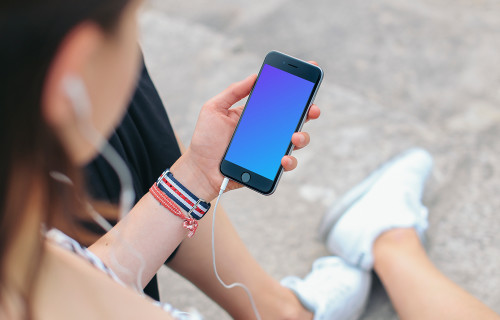 Sitting with iPhone 6 mockup and Headphones