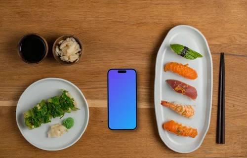 Smartphone mockup au milieu des assiettes de sushi