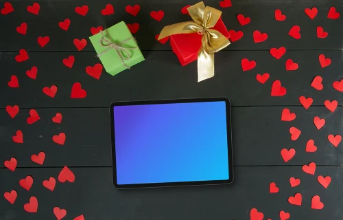 Tablet mockup surrounded by hearts and gifts