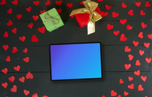 Tablet mockup surrounded by hearts and gifts