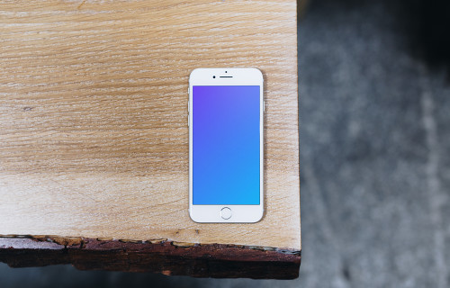 Top view mockup of iPhone 7 Silver mockup on the wooden table