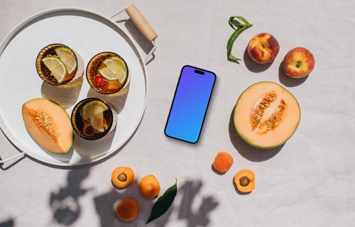 Top view of phone mockup next to the fresh fruits