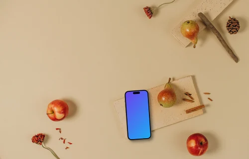 Top view of phone mockup with apples around