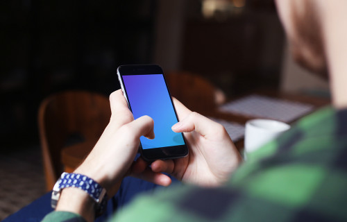 Typing on iPhone 6 mockup screen at coffee