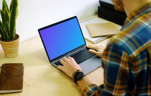 Typing on Macbook Pro mockup on desk
