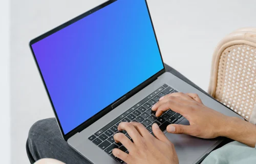 User typing on a MacBook mockup