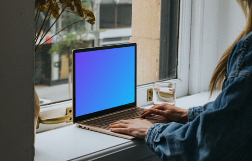 Woman sitting and working on the Microsoft Surface Laptop mockup