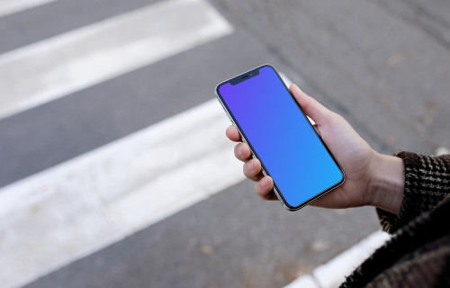 Woman walking down the street with iPhone X mockup