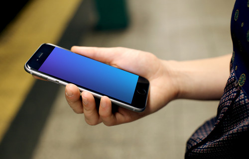 Woman with iPhone 6s mockup in Underground Station