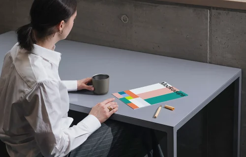 A4 mockup on a gray desk with office elements