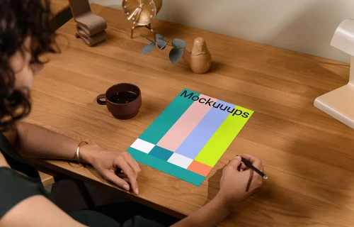A4 mockup on a wooden desk with decor items