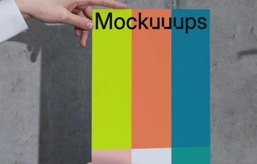 A4 paper mockup held against a concrete wall
