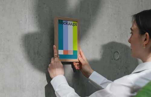 A5 mockup in wooden frame against concrete wall