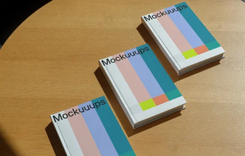 B-format book mockup on a round wooden table in natural light