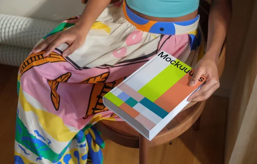 Book mockup held by a person in colorful attire