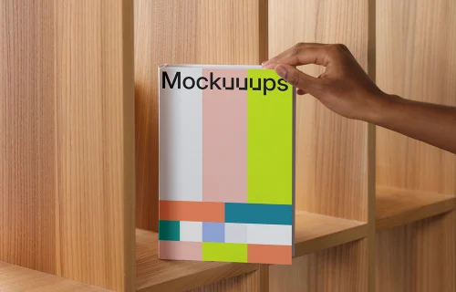 Book mockup on a wooden shelf with hand placement