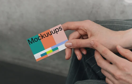 Business card mockup in hands against neutral background