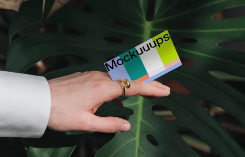 Business card mockup with gradient over a green leaf