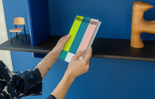 C-format book mockup held in a modern interior