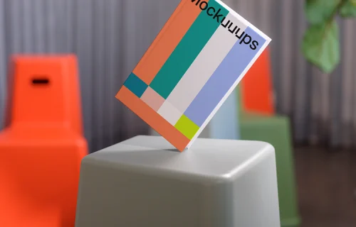 C-format book mockup held over modern stools
