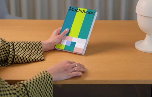 C-format book mockup on a wooden desk