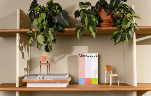 C-format book mockup on a wooden shelf with decor