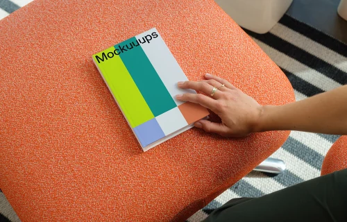 C-format book mockup on an orange ottoman