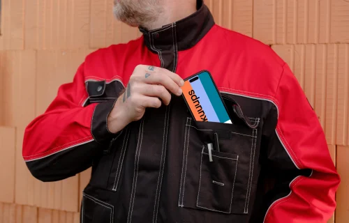 Construction worker with a phone in his pocket