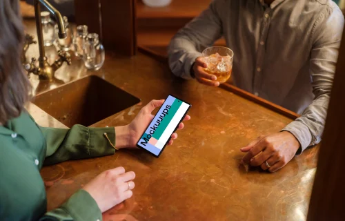 Cozy lounge and woman holding a phone mockup