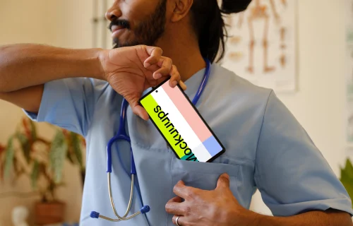 Doctor taking Google Pixel 6 out of his pocket