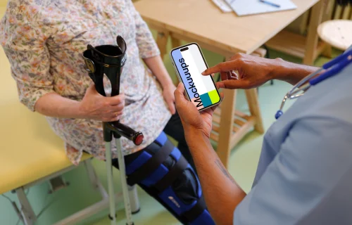 Doctor typing on an iPhone