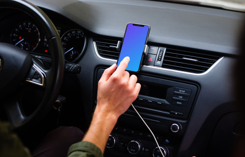Driver interacting with iPhone 11 mockup in car mount