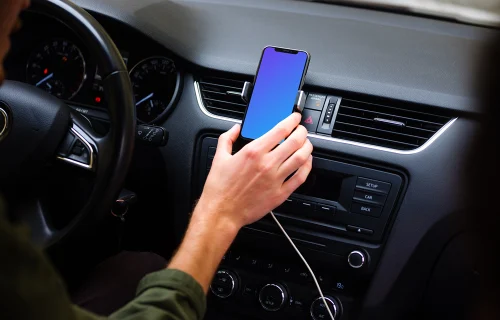 Driver placing iPhone 11 mockup in car mount