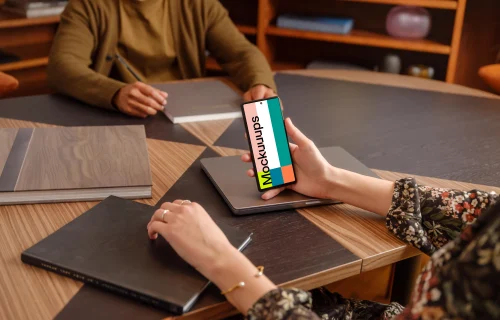Female hand holding a Google Pixel 6 mockup in the office