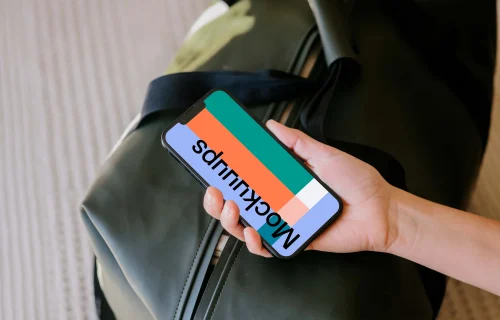 Female hand holding an iPhone mockup