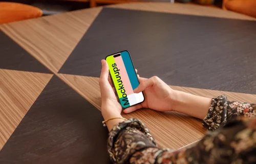 Female holding a iPhone mockup in the office