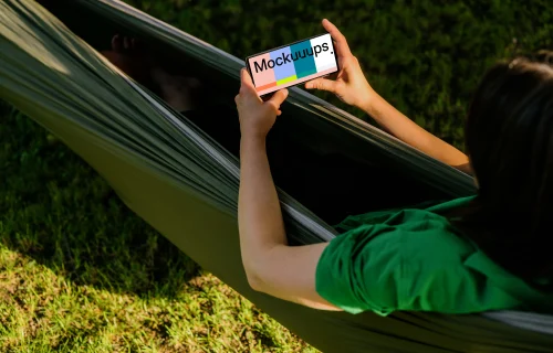 Female laying in a hammock while holding a Google Pixel 6 mockup