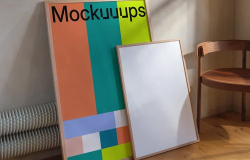 Framed poster mockup leaning against a wall with chair
