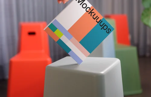 Hand-held square book mockup with modern seating