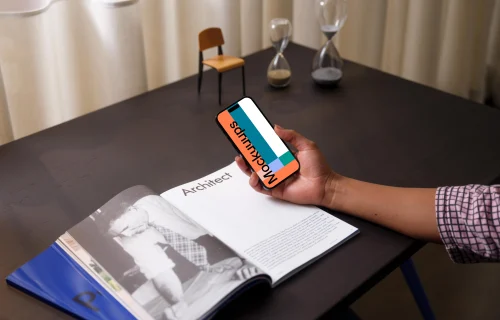 Hand holding an iPhone 14 Pro mockup